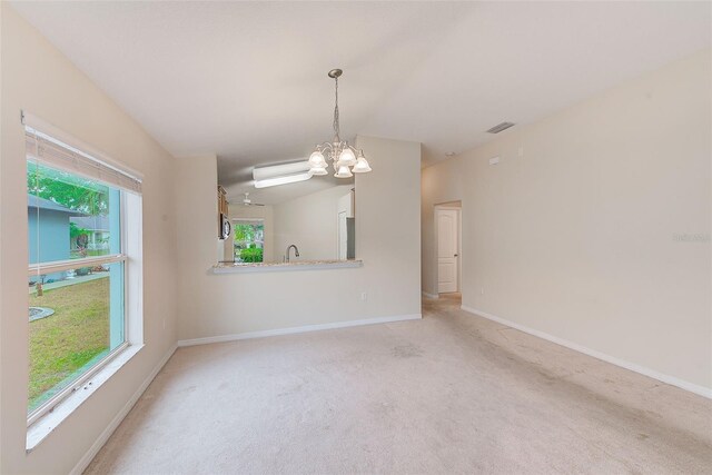 15410 Quail Woods Pl, Ruskin, FL 33573 - empty room with baseboards, an inviting chandelier, visible vents, light colored carpet, and a sink