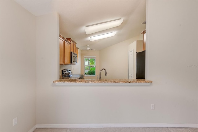 15410 Quail Woods Pl, Ruskin, FL 33573 - kitchen with brown cabinets, a sink, baseboards, and stainless steel appliances
