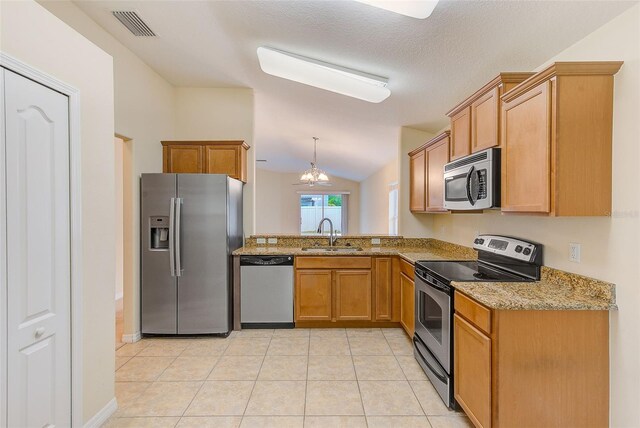 15410 Quail Woods Pl, Ruskin, FL 33573 - kitchen featuring light tile patterned floors, vaulted ceiling, light stone counters, a sink, and stainless steel appliances