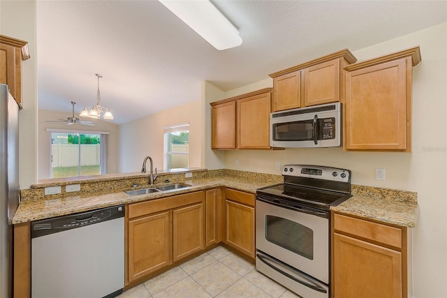 15410 Quail Woods Pl, Ruskin, FL 33573 - kitchen with stainless steel appliances, light stone countertops, light tile patterned floors, and a sink