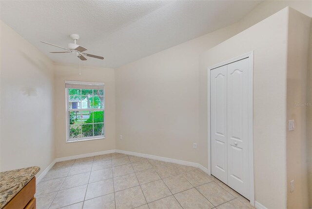 15410 Quail Woods Pl, Ruskin, FL 33573 - empty room featuring light tile patterned floors, baseboards, and a ceiling fan