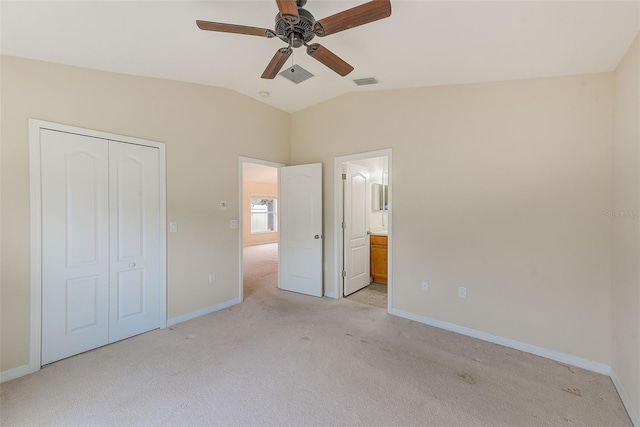 15410 Quail Woods Pl, Ruskin, FL 33573 - unfurnished bedroom featuring a closet, light colored carpet, vaulted ceiling, visible vents, and baseboards