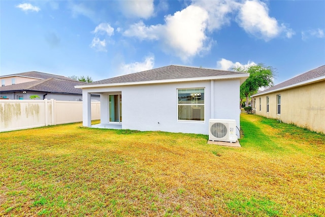 15410 Quail Woods Pl, Ruskin, FL 33573 - rear view of property featuring a yard, stucco siding, fence, and ac unit