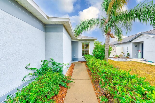 15410 Quail Woods Pl, Ruskin, FL 33573 - view of exterior entry featuring stucco siding