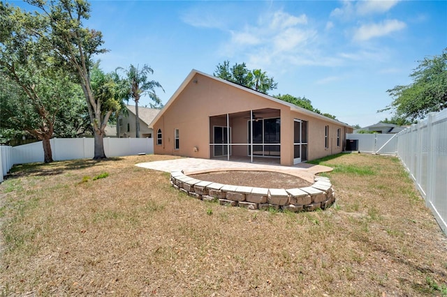 2745 Buckhorn Preserve Blvd, Valrico, FL 33596 - rear view of house with stucco siding, a fenced backyard, a sunroom, and a lawn