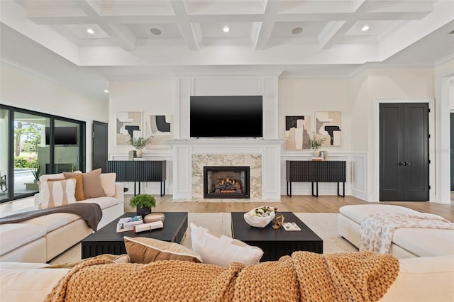 living area featuring wood finished floors, ornamental molding, beam ceiling, and recessed lighting