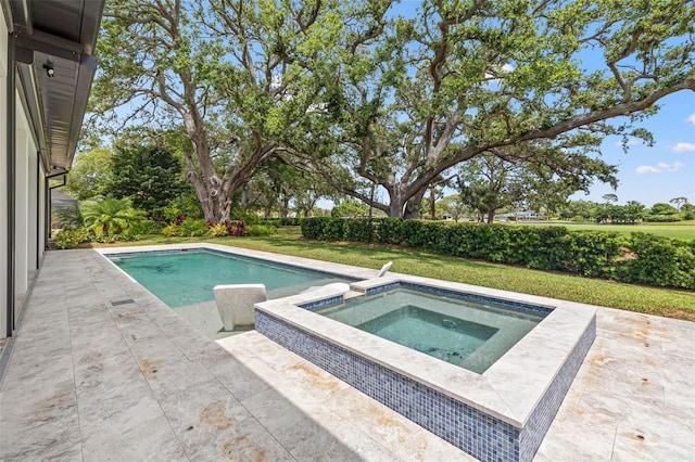 pool featuring a yard, a patio area, and an in ground hot tub