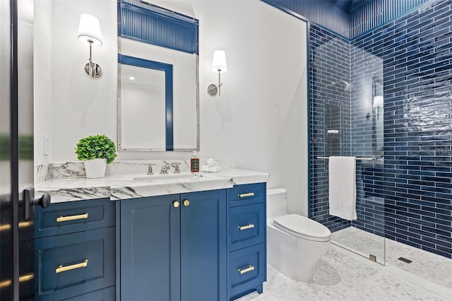 full bath featuring a tile shower, toilet, and vanity