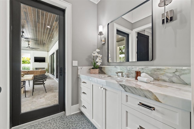 bathroom with baseboards and vanity