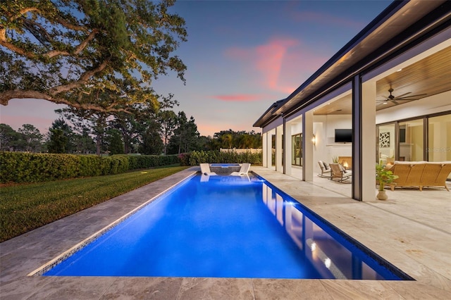 view of swimming pool with a patio area, a pool with connected hot tub, and a ceiling fan