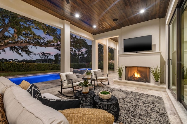view of patio / terrace featuring an outdoor pool and an outdoor living space with a fireplace