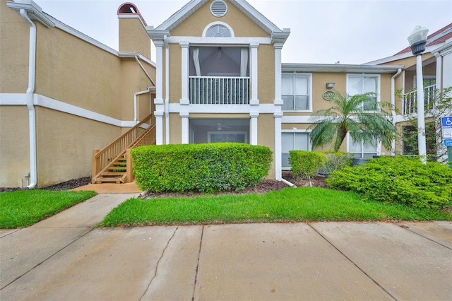 9481 Highland Oak Dr Unit 1206, Tampa, FL 33647 - view of front facade with stucco siding and stairway