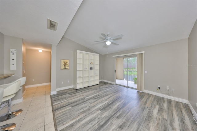 9481 Highland Oak Dr Unit 1206, Tampa, FL 33647 - unfurnished living room featuring a ceiling fan, lofted ceiling, and light wood-type flooring