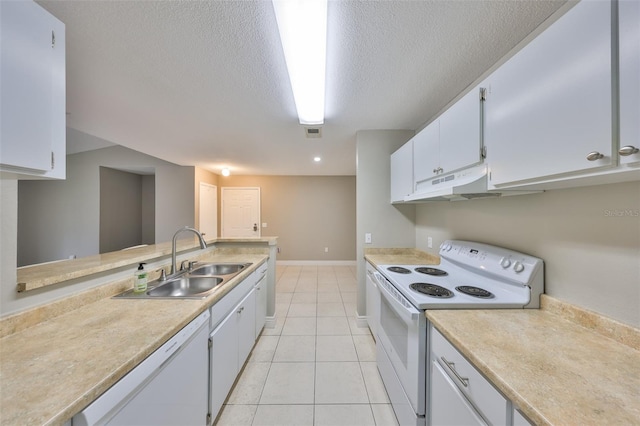 9481 Highland Oak Dr Unit 1206, Tampa, FL 33647 - kitchen featuring white appliances, under cabinet range hood, light countertops, white cabinetry, and a textured ceiling