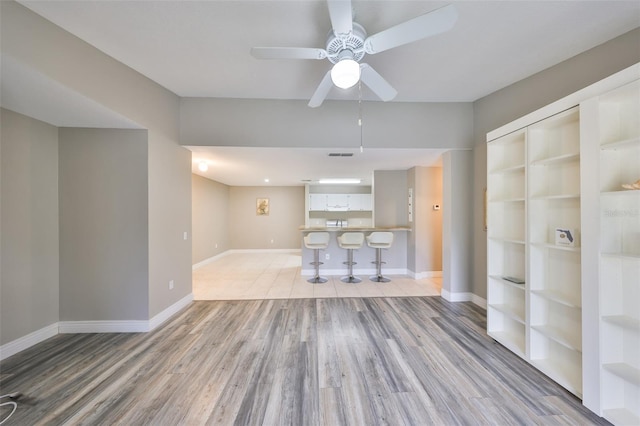 9481 Highland Oak Dr Unit 1206, Tampa, FL 33647 - unfurnished living room with light wood finished floors and a ceiling fan
