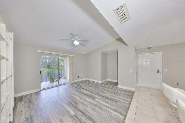 9481 Highland Oak Dr Unit 1206, Tampa, FL 33647 - unfurnished living room featuring ceiling fan, light wood finished floors, and lofted ceiling