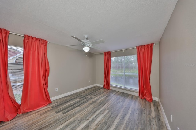 9481 Highland Oak Dr Unit 1206, Tampa, FL 33647 - spare room featuring wood finished floors, a ceiling fan, and a textured ceiling