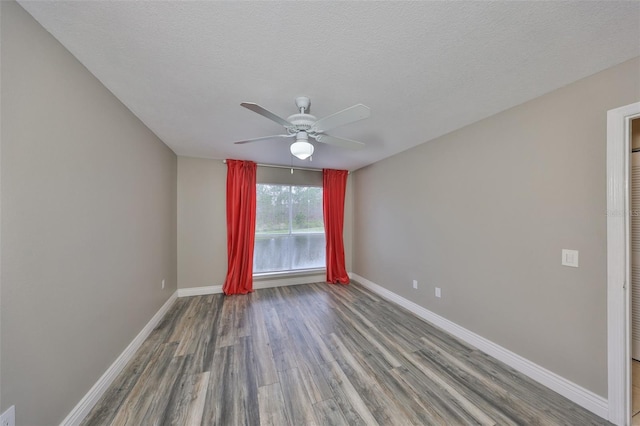 9481 Highland Oak Dr Unit 1206, Tampa, FL 33647 - unfurnished room featuring wood finished floors, a ceiling fan, and a textured ceiling