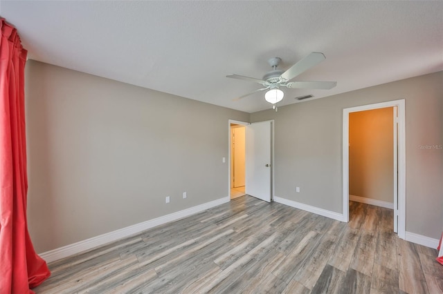 9481 Highland Oak Dr Unit 1206, Tampa, FL 33647 - unfurnished bedroom featuring wood finished floors and ceiling fan