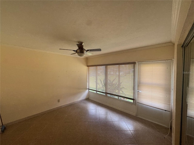 empty room with crown molding, baseboards, a ceiling fan, and a textured ceiling