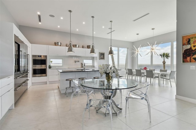 90 Martinique Ave, Tampa, FL 33606 - dining space with light tile patterned floors, visible vents, and recessed lighting