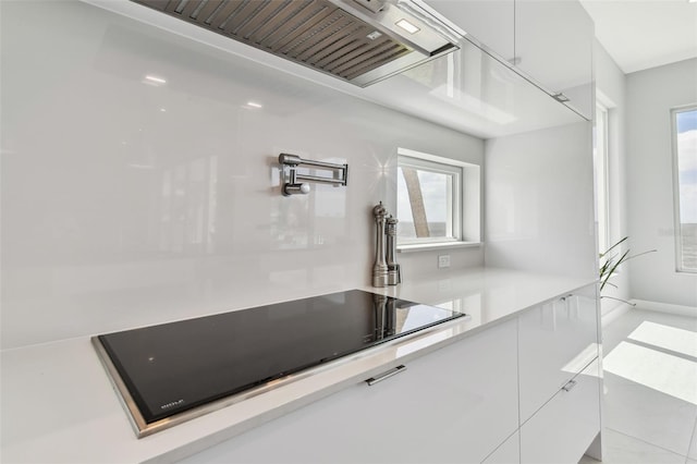 90 Martinique Ave, Tampa, FL 33606 - kitchen with white cabinets, black electric cooktop, modern cabinets, tile patterned flooring, and light countertops