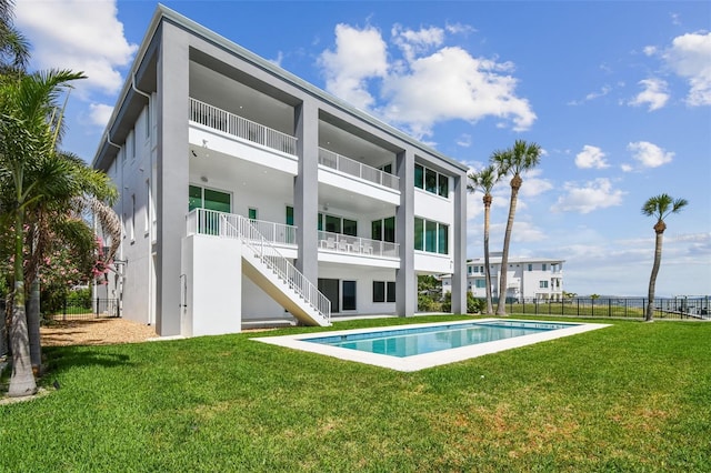 90 Martinique Ave, Tampa, FL 33606 - back of house with stucco siding, stairway, fence, and a fenced in pool