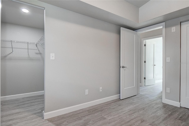 empty room featuring wood finished floors and baseboards