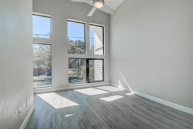 interior space with high vaulted ceiling, baseboards, and a healthy amount of sunlight