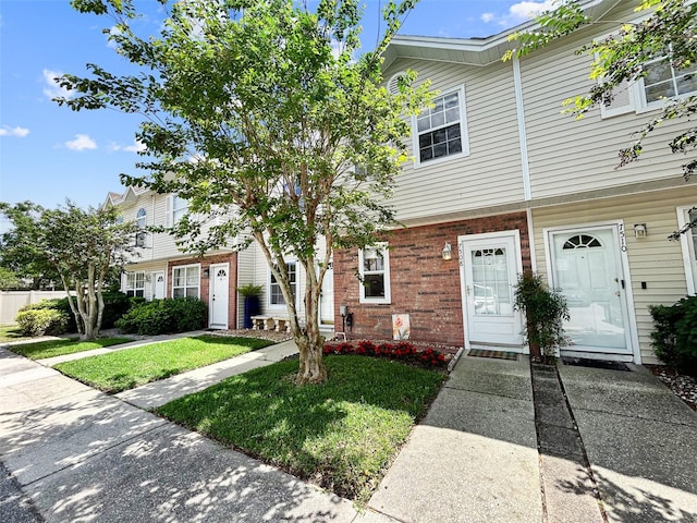 7508 Hollowell Dr, Tampa, FL 33615 - multi unit property with brick siding and a front lawn