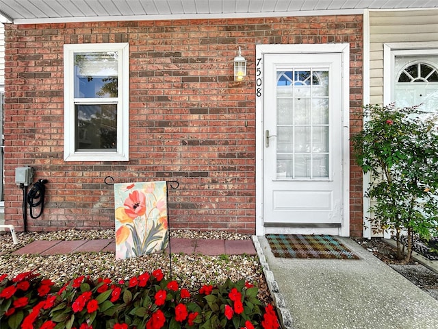 7508 Hollowell Dr, Tampa, FL 33615 - doorway to property with brick siding