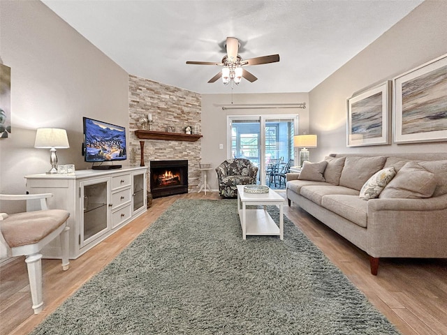 7508 Hollowell Dr, Tampa, FL 33615 - living room featuring light wood-style flooring, ceiling fan, and a fireplace
