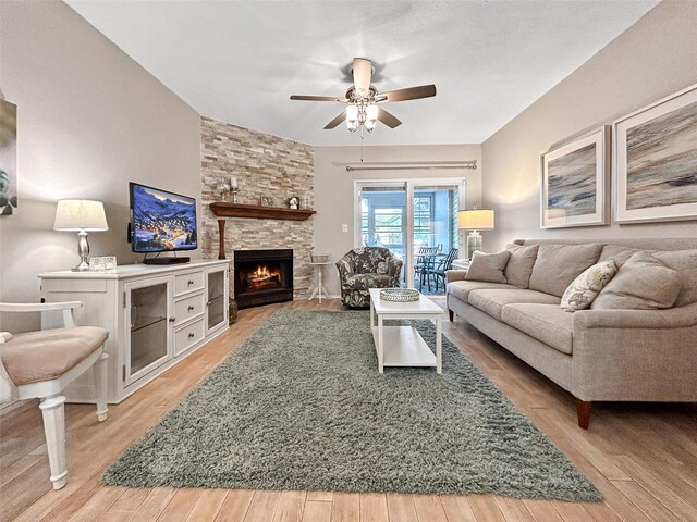 7508 Hollowell Dr, Tampa, FL 33615 - living area featuring light wood finished floors, ceiling fan, and a stone fireplace