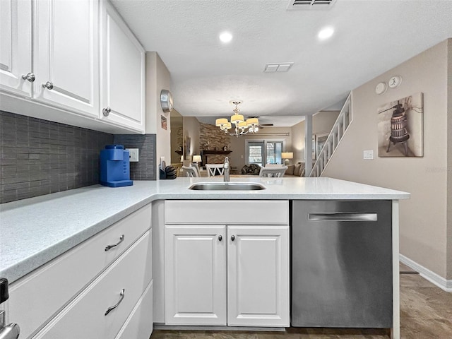 7508 Hollowell Dr, Tampa, FL 33615 - kitchen featuring an inviting chandelier, a peninsula, visible vents, dishwasher, and decorative backsplash