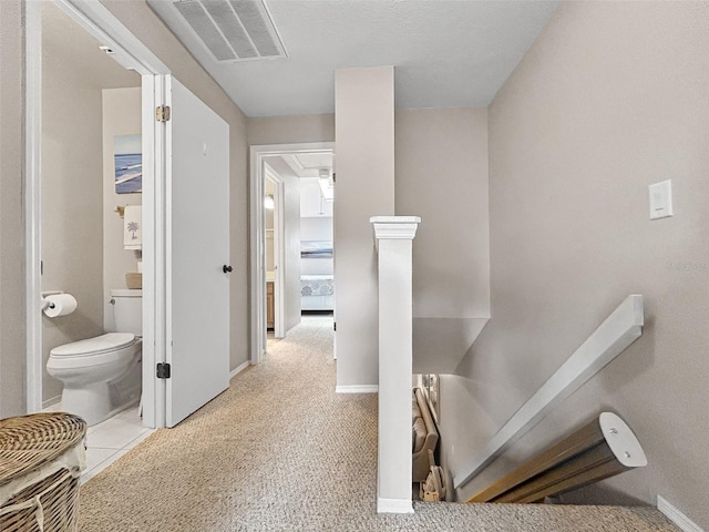 7508 Hollowell Dr, Tampa, FL 33615 - hallway with attic access, baseboards, and visible vents