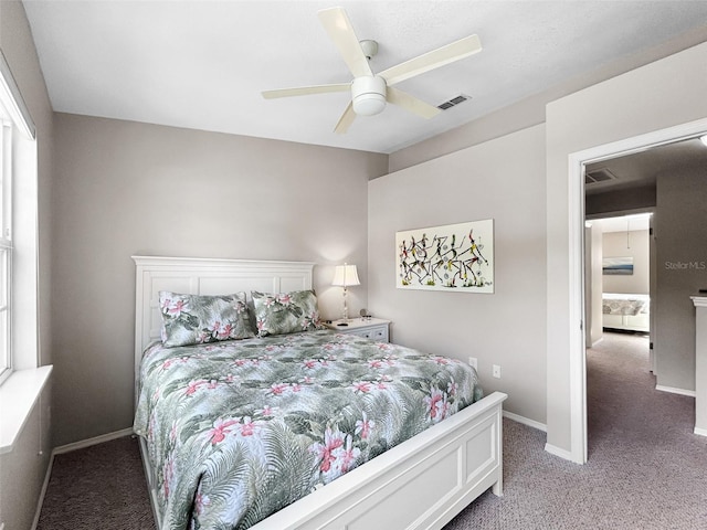 7508 Hollowell Dr, Tampa, FL 33615 - bedroom with visible vents, baseboards, a ceiling fan, and light carpet