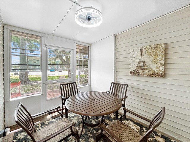 7508 Hollowell Dr, Tampa, FL 33615 - dining area featuring wooden walls and a ceiling fan