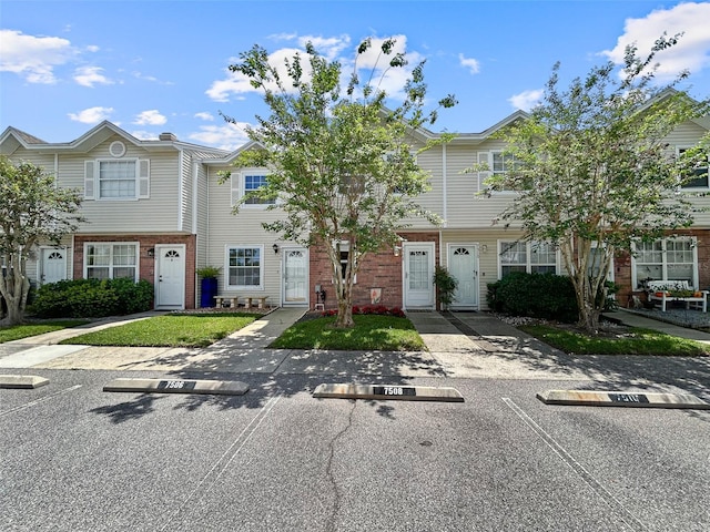 7508 Hollowell Dr, Tampa, FL 33615 - townhome / multi-family property featuring brick siding and uncovered parking