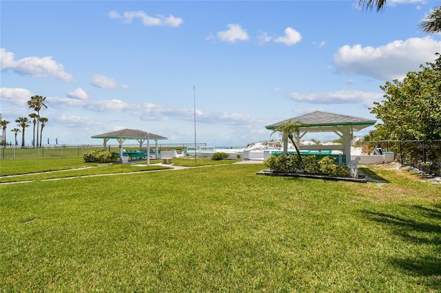 surrounding community with a gazebo, fence, and a yard