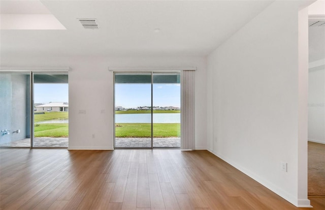 10317 Cross River Trl, Parrish, FL 34219 - spare room featuring wood finished floors and a water view