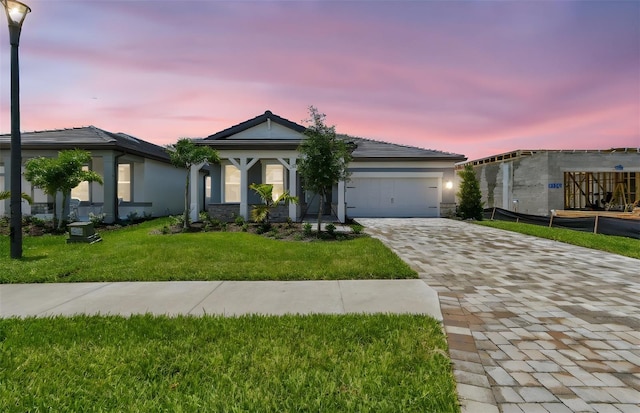 10317 Cross River Trl, Parrish, FL 34219 - single story home featuring decorative driveway, a garage, a yard, and stucco siding