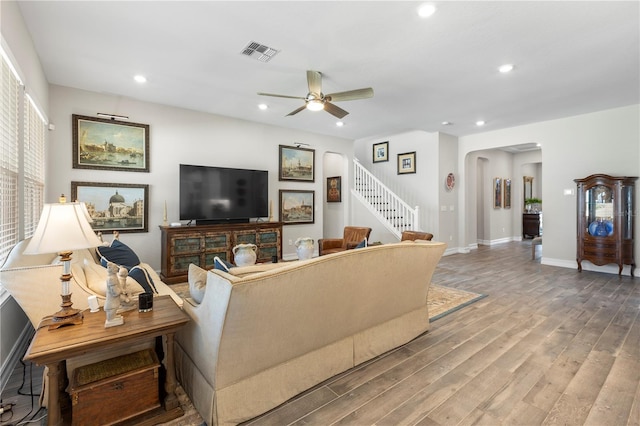 4365 Frontera Ln, Wesley Chapel, FL 33543 - living area featuring arched walkways, visible vents, a ceiling fan, wood finished floors, and stairs