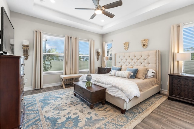 4365 Frontera Ln, Wesley Chapel, FL 33543 - bedroom with wood finished floors, ceiling fan, a raised ceiling, baseboards, and recessed lighting