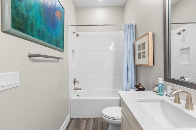 4365 Frontera Ln, Wesley Chapel, FL 33543 - full bath featuring wood finished floors, toilet, vanity, baseboards, and shower / tub combo