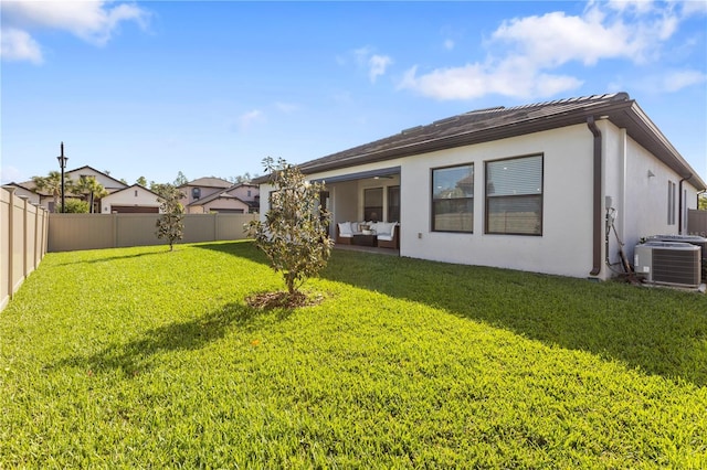 4365 Frontera Ln, Wesley Chapel, FL 33543 - back of property featuring a fenced backyard, cooling unit, a yard, stucco siding, and an outdoor living space