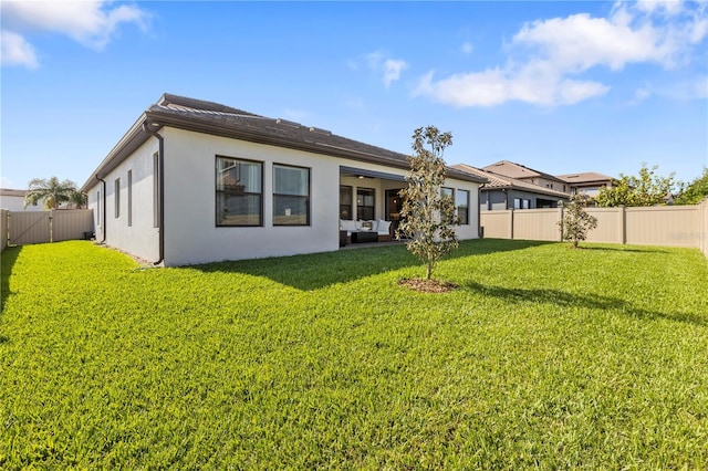 4365 Frontera Ln, Wesley Chapel, FL 33543 - back of house with a lawn, a fenced backyard, and stucco siding
