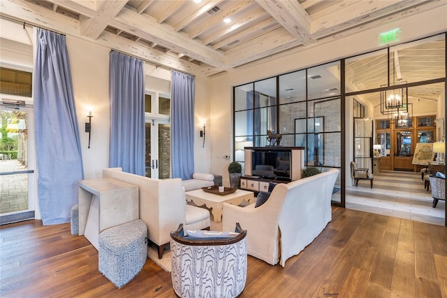 4365 Frontera Ln, Wesley Chapel, FL 33543 - living room with wood-type flooring, coffered ceiling, a chandelier, and beamed ceiling