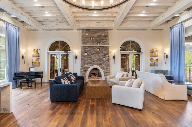 4365 Frontera Ln, Wesley Chapel, FL 33543 - living area featuring a stone fireplace, french doors, dark wood-style flooring, beam ceiling, and recessed lighting