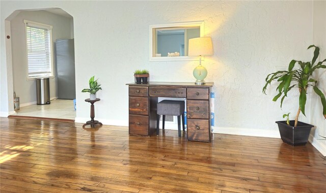3545 7th Ave N, Saint Petersburg, FL 33713 - home office featuring arched walkways, baseboards, and hardwood / wood-style flooring