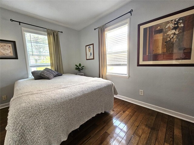 3545 7th Ave N, Saint Petersburg, FL 33713 - bedroom featuring dark wood-style flooring, multiple windows, and baseboards